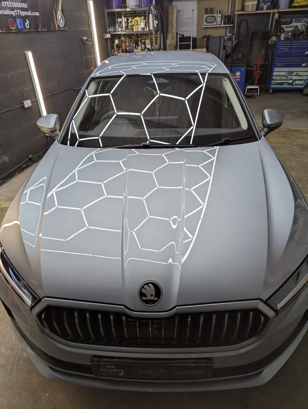 Grey Skoda with ceramic-coated bonnet under hex lighting